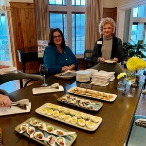 2 women at table with food
