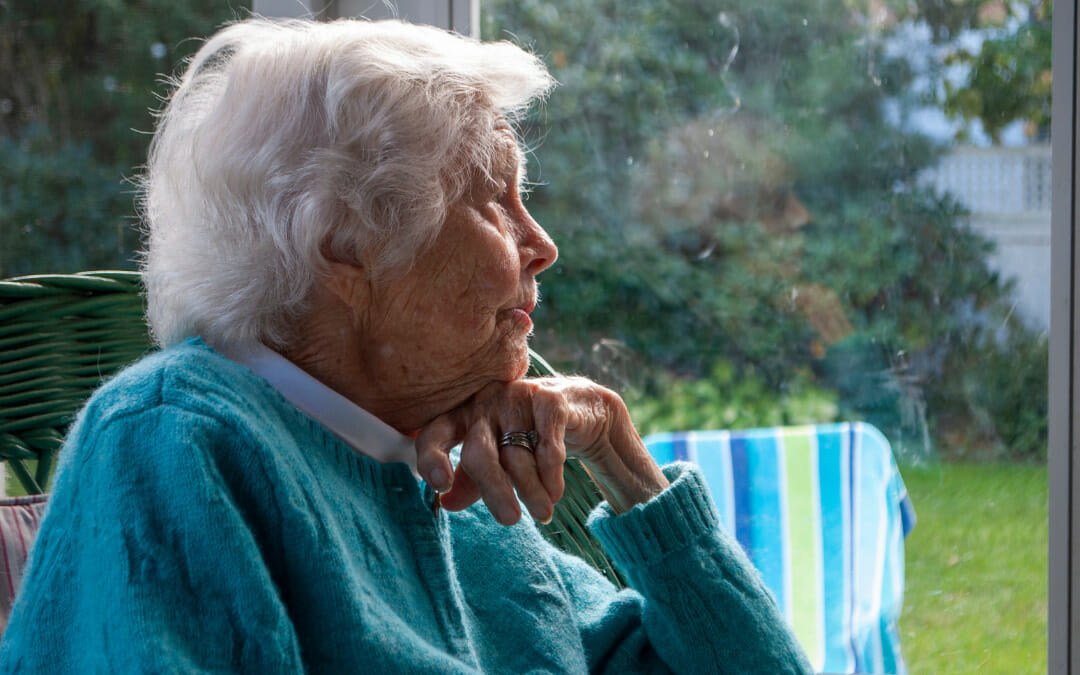 Older woman looking out the window