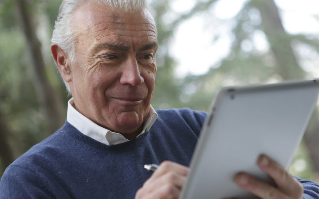Older man taking notes